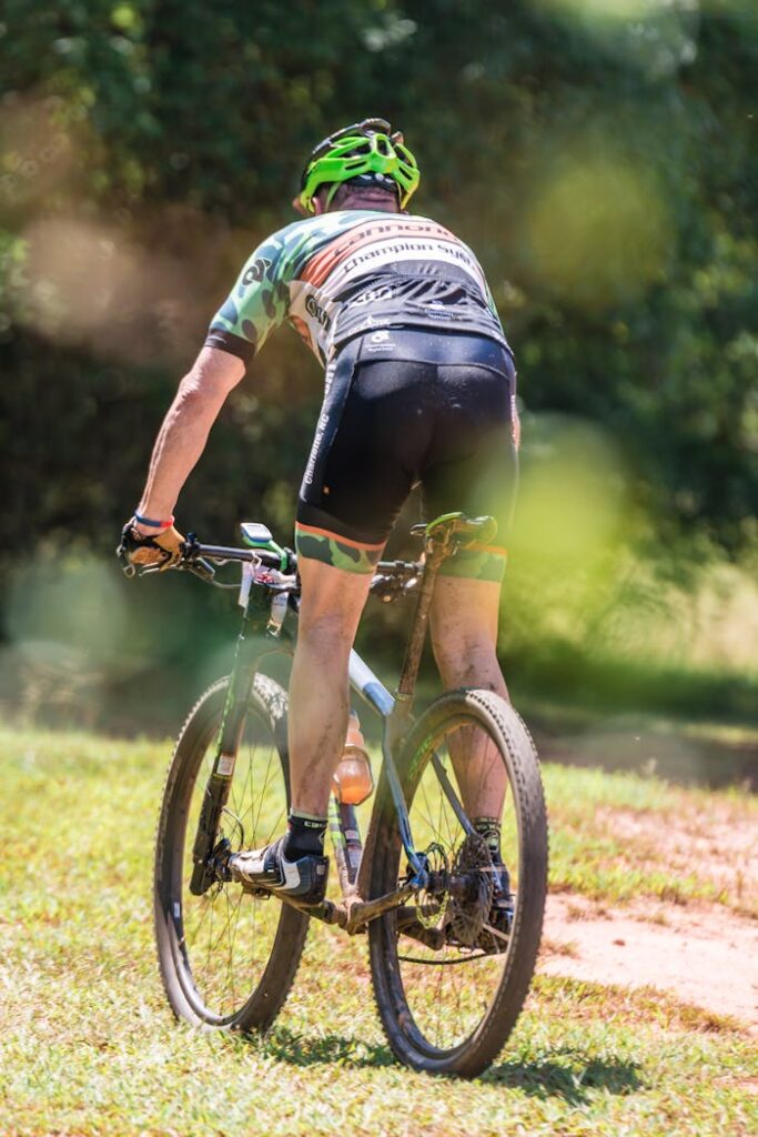 A cyclist rides on a sunny outdoor trail, showcasing energy and adventure.